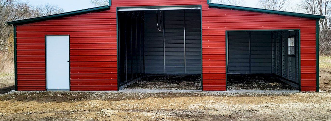Classic red steel barn with black roof and dual lean-tos