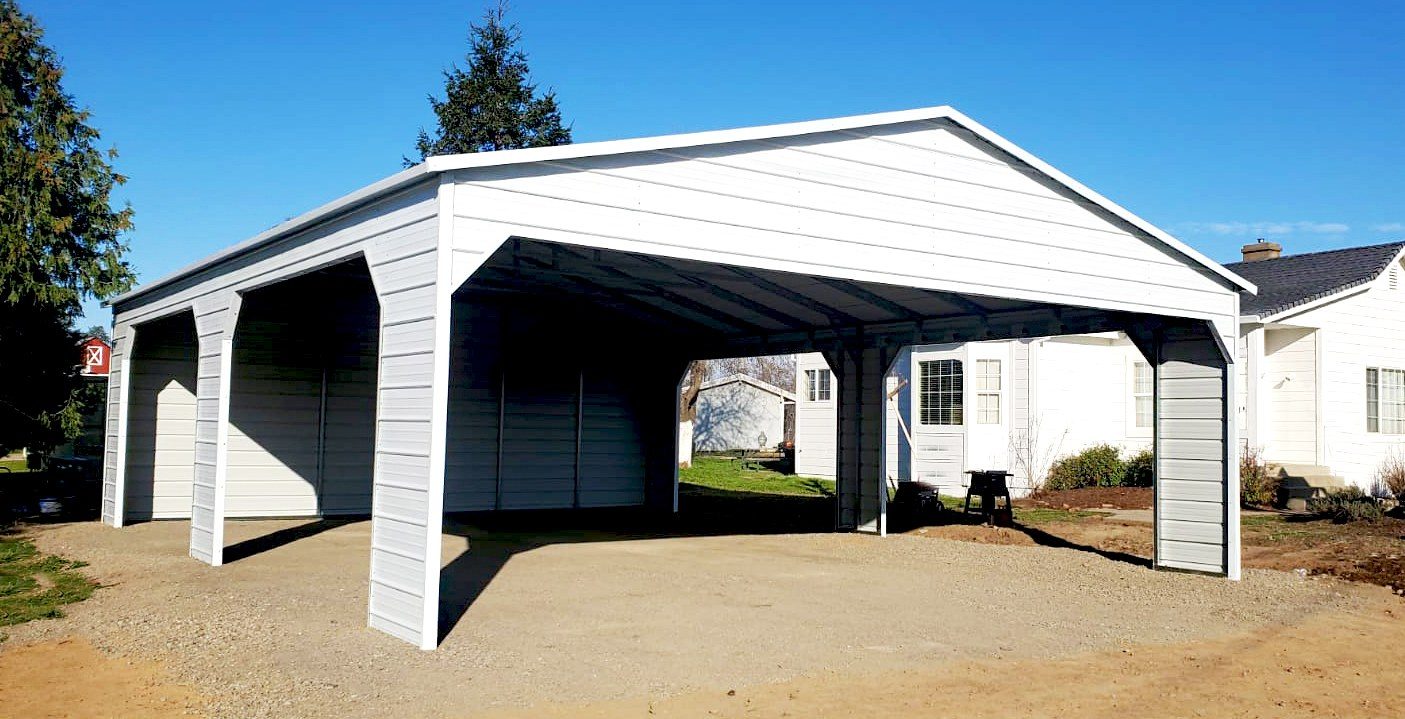 White residential steel carport with scalloped trim beside a home