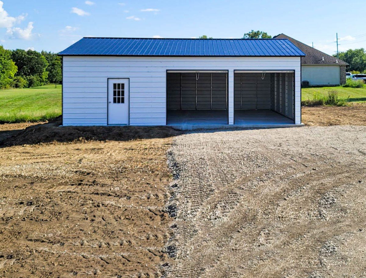White steel garage with blue vertical roof and walk-in door