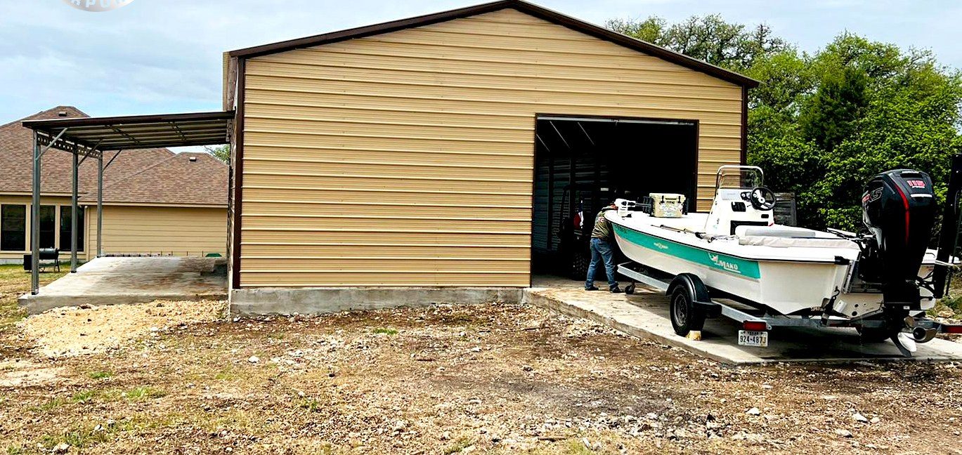 Tan steel garage used for boat storage with wide roll-up bay