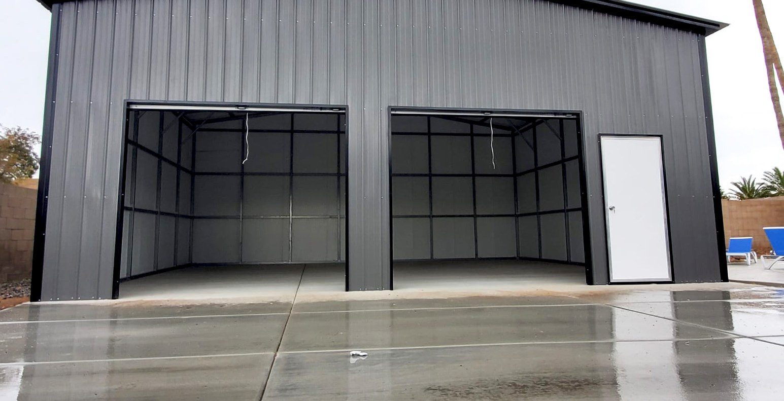 Charcoal steel garage with two open bays and walk-in door