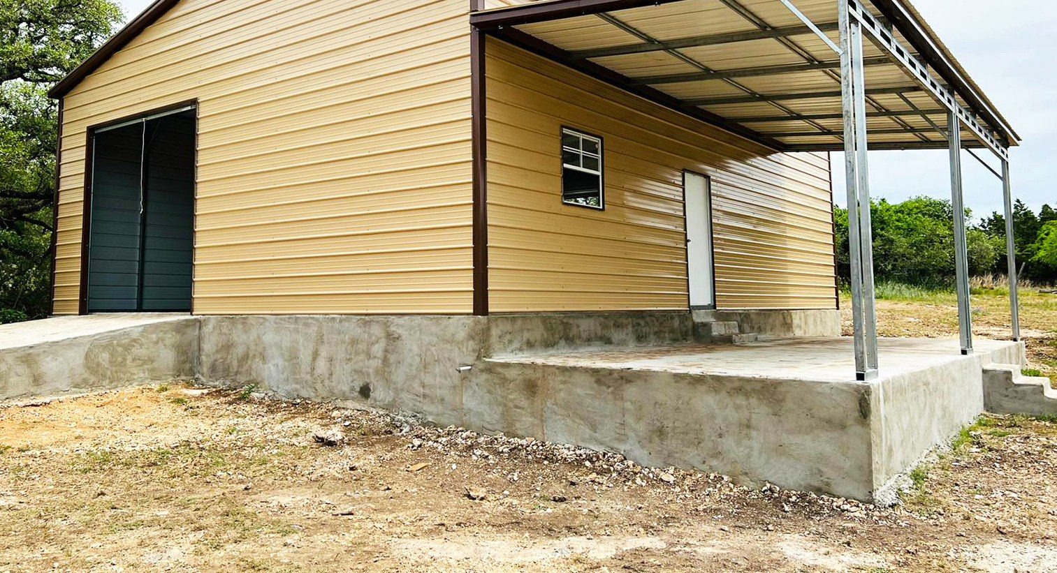 Tan steel garage with attached lean-to porch on concrete slab